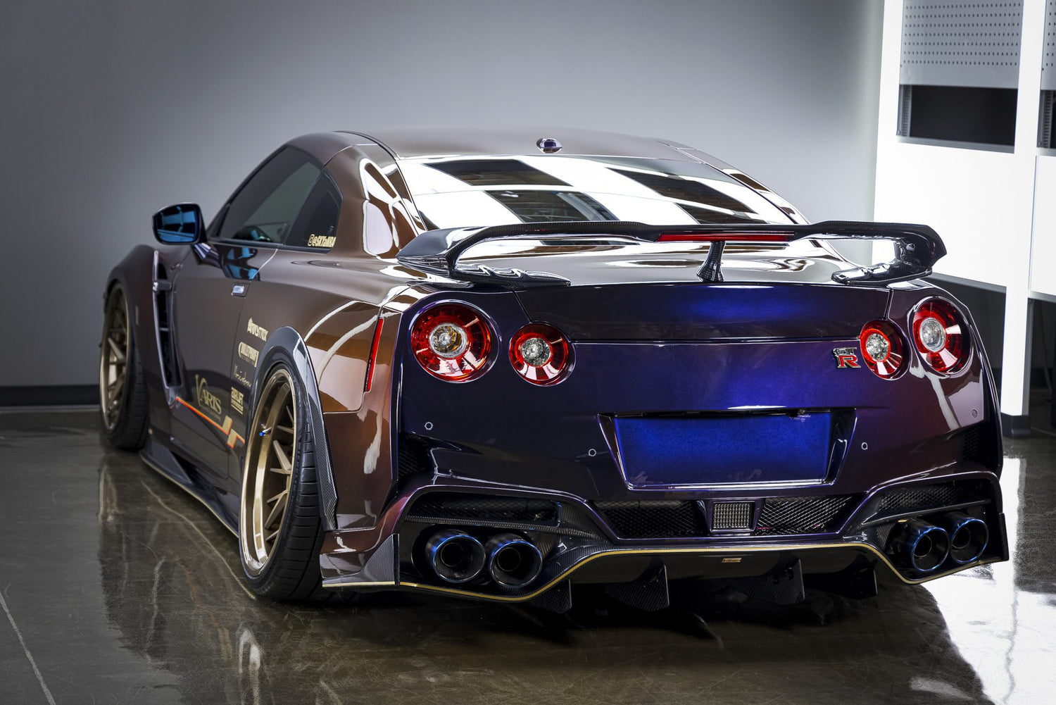The rear view of a stunning Midnight Purple Nissan GT-R, exhibiting the exceptional results of professional car detailing near me in Sydney, New South Wales, Australia. The deep, lustrous paint finish and attention to detail on the spoiler, taillights, and exhaust system showcase the high quality of car detailing services available. If you're seeking meticulous detailing near me to enhance the beauty of your sports car, this Nissan GT-R perfectly illustrates the potential outcome.