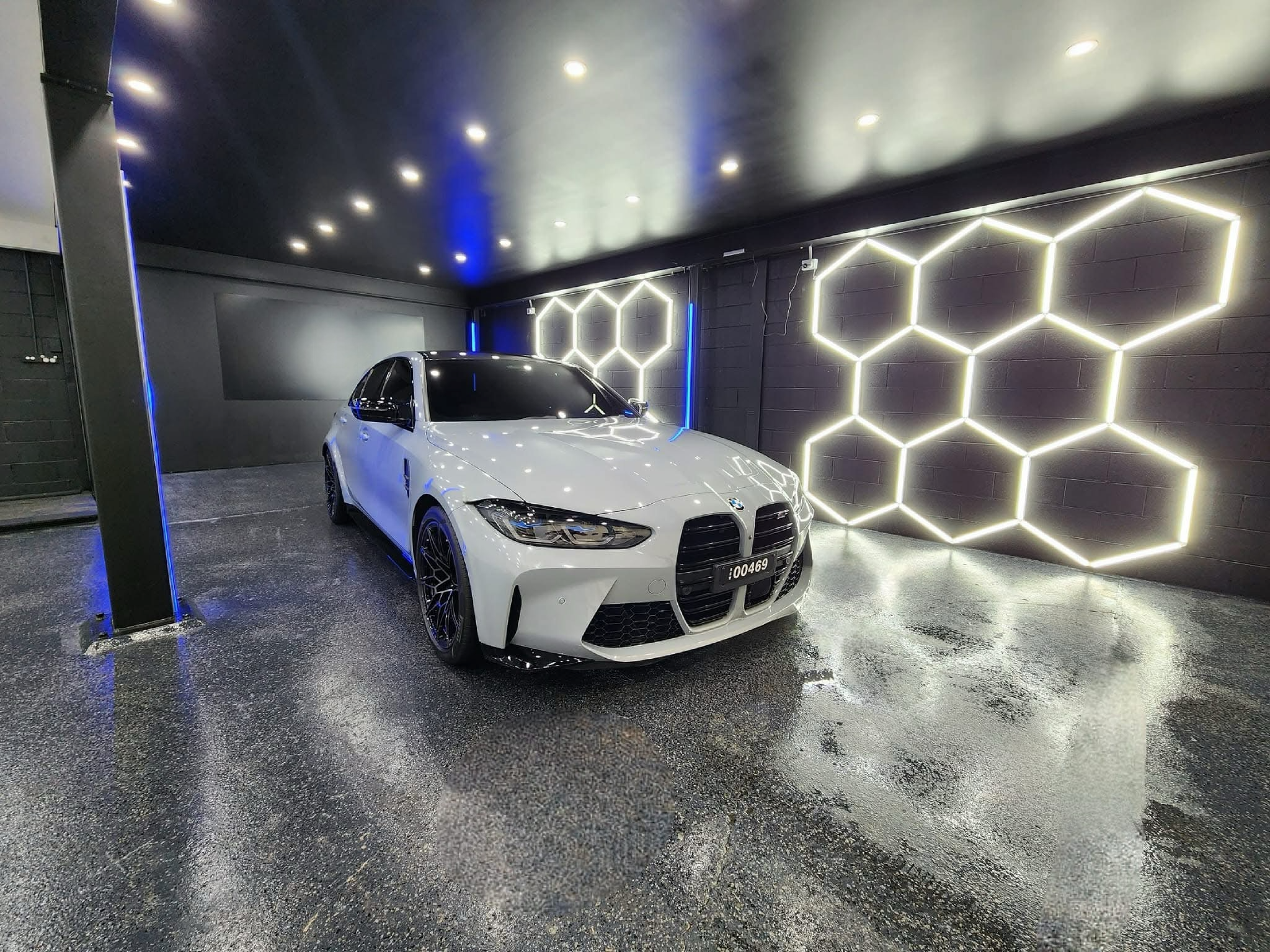 A gleaming white BMW M3, likely a 2021 or newer model (G80), showcasing the exceptional gloss and protection achieved through a professional ceramic coating application and comprehensive car detailing at our center in Western Sydney, Chipping Norton. The image highlights the pristine paint finish and meticulous detailing of the vehicle's exterior, demonstrating the high-quality ceramic coating and car detailing services available near you in Western Sydney. If you're looking for premium ceramic coating.