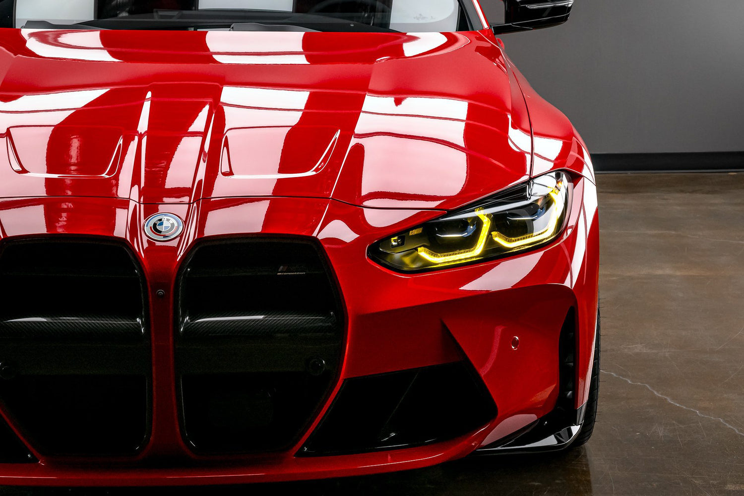 A vibrant red BMW M3 (G80) showcasing the flawless paint after professional paint correction and the enhanced gloss from a ceramic coating application near me in Sydney, New South Wales, Australia. The image highlights the deep reflections and smooth finish achieved through meticulous paint correction, followed by the durable protection of a ceramic coating available near you. If you're seeking to eliminate paint imperfections and add long-lasting shine with ceramic coating near me for your BMW M3.